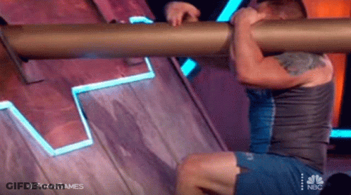 Man Doing Pull Ups On Wooden Wall Holding Pipe GIF