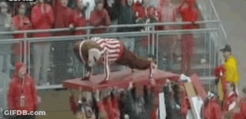 Man Doing Push Ups On Table In Front Of Crowd GIF