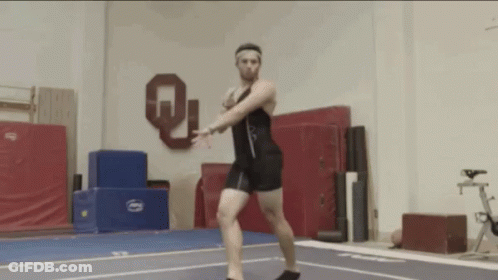 Man Doing Trick On Gym Floor With Letter Q GIF