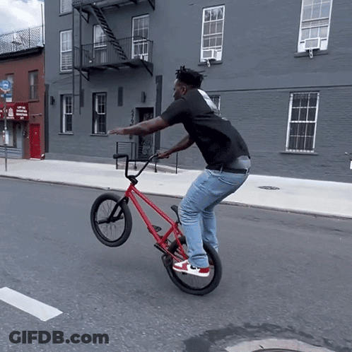 Man Doing Trick On Red Bicycle GIF