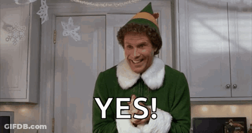 Man Dressed As Christmas Elf Smiling Saying Yes In Kitchen GIF