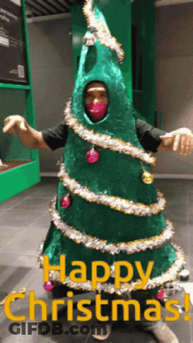 Man Dressed As Christmas Tree Saying Happy Christmas GIF