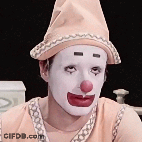 Man Dressed As Clown With Red Nose And White Face Paint GIF