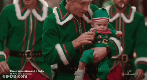 Man Dressed As Elf Holding Baby GIF