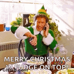 Man Dressed As Elf Talking On Phone Pouring Fudge On Popcorn GIF