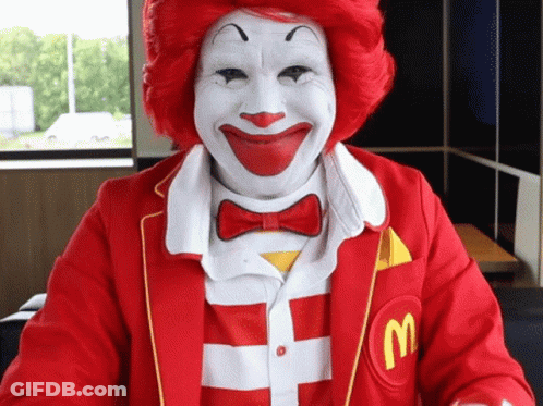 Man Dressed As Ronald McDonald With Red Hair And White Face Paint GIF