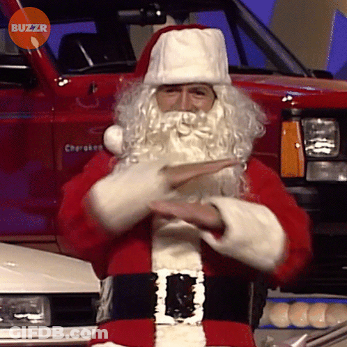 Man Dressed As Santa Claus In Front Of Red Cherokee Truck GIF