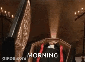 Man Dressed As Vampire Adjusting Mask GIF