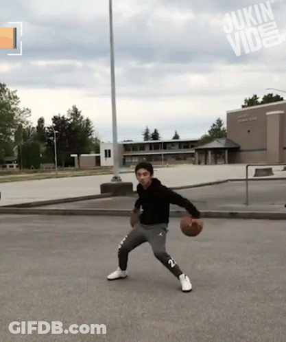 Man Dribbling Basketball In Front Of Sukin Building GIF