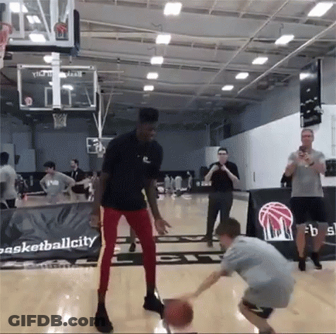 Man Dribbling Basketball Near Basketballcity Sign GIF