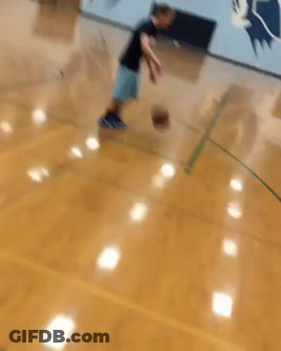 Man Dribbling Basketball Past Defender GIF