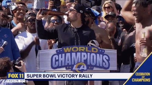 Man Drinking Beer In Front Of World Champions Sign GIF