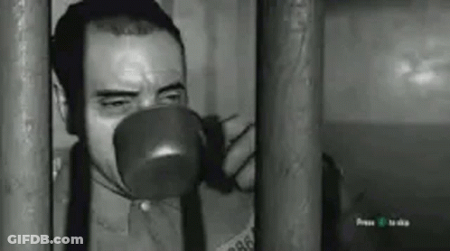 Man Drinking Behind Bars GIF