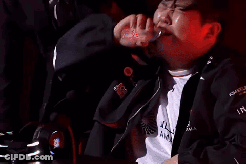 Man Drinking Bottle In Dark Room With Another Watching GIF