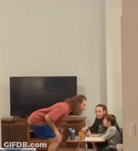 Man Drinking Bottle While Woman And Kids Homework GIF