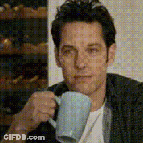 Man Drinking Coffee Looking At Camera GIF