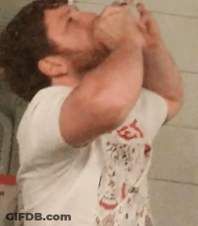 Man Drinking From Bottle In Bathroom GIF