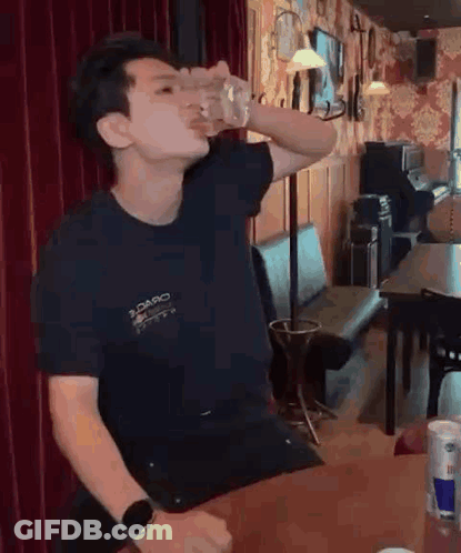Man Drinking From Glass At Bar GIF