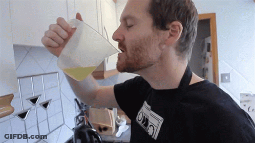 Man Drinking From Measuring Cup With Ovo Shirt GIF