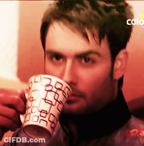 Man Drinking From Mug With Square Pattern GIF