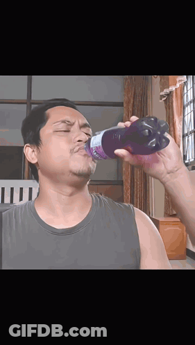 Man Drinking From Purple Strawberry Bottle GIF
