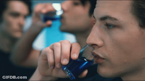 Man Drinking From Shot Glass With Blue Liquid GIF