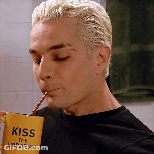 Man Drinking From Yellow Cup Saying Kiss The Librarian GIF