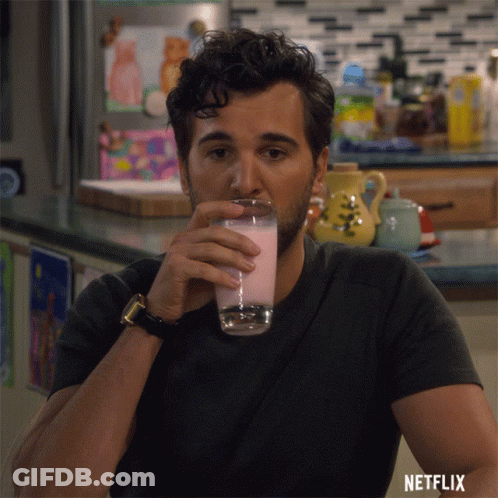 Man Drinking Glass With Netflix Logo GIF