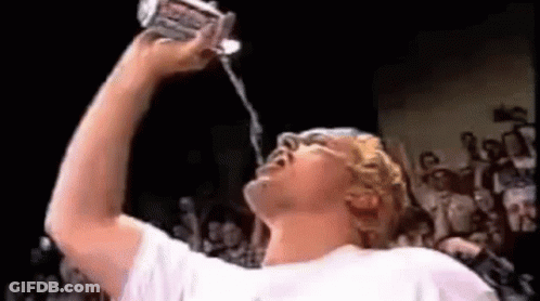 Man Drinking Water From Can While Crowd Watches GIF