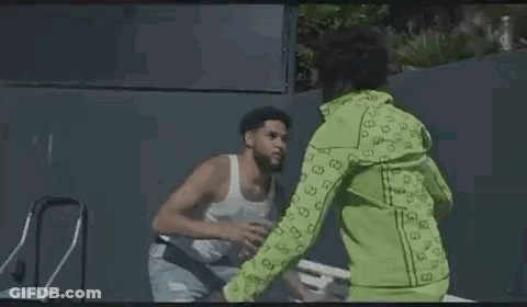 Man Drinking Water From Plastic Bottle Next To Another Man On Park Bench GIF