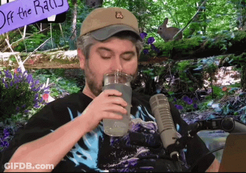 Man Drinking Water In Front Of Off The Rail Sign GIF
