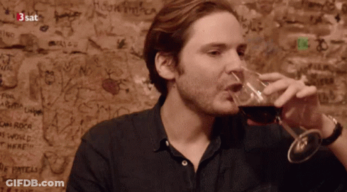 Man Drinking Wine In Front Of 3Sat Graffiti GIF