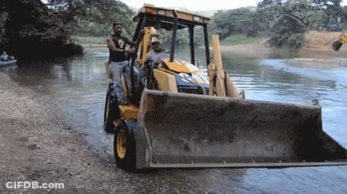Man Driving Bulldozer In Water GIF