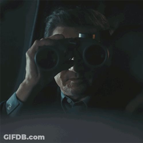 Man Driving Car In Dark Looking Out Window GIF