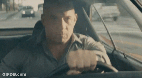 Man Driving Car Looking At Camera GIF