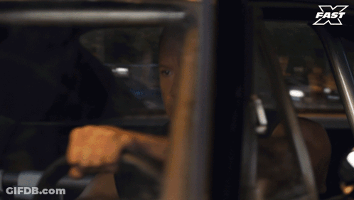 Man Driving Car With X Fast Logo GIF