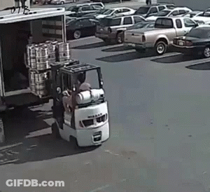 Man Driving Forklift Loading Barrels Into Truck GIF