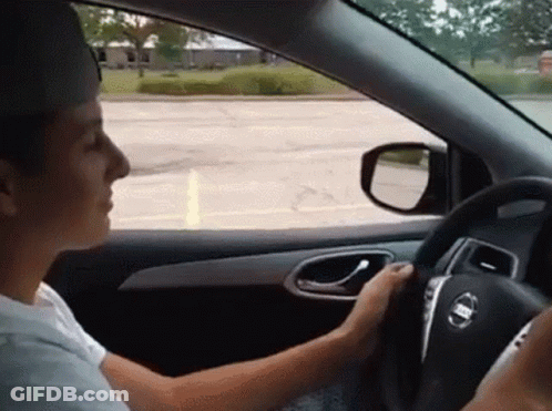 Man Driving Nissan Car And Looking Out Window GIF