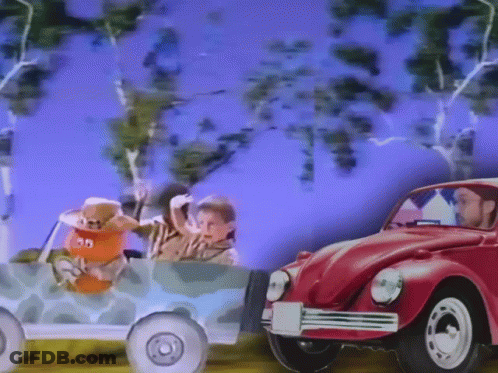 Man Driving Red Car Next To Toy Car 30 GIF