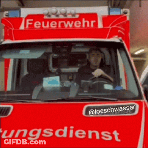 Man Driving Red Feuerwehr Ungdienst Vehicle GIF