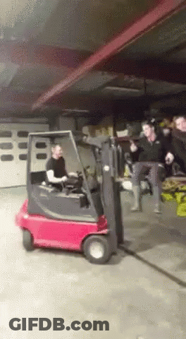 Man Driving Red Forklift In Warehouse GIF