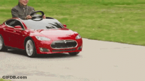 Man Driving Red Tesla Model S Toy Car GIF