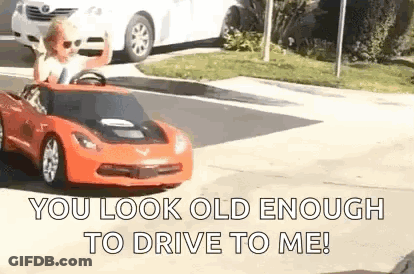 Man Driving Red Toy Car On Street GIF