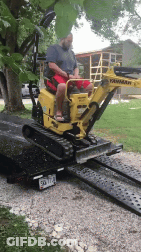 Man Driving Yanmar Excavator On Ramp GIF