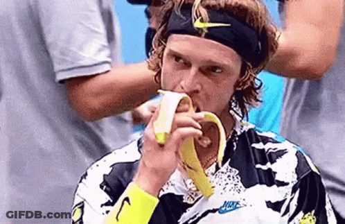Man Eating Banana With Nike Headband GIF