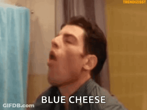 Man Eating Blue Cheese In Bathroom GIF
