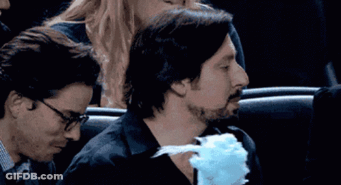 Man Eating Blue Cotton Candy In Theater GIF