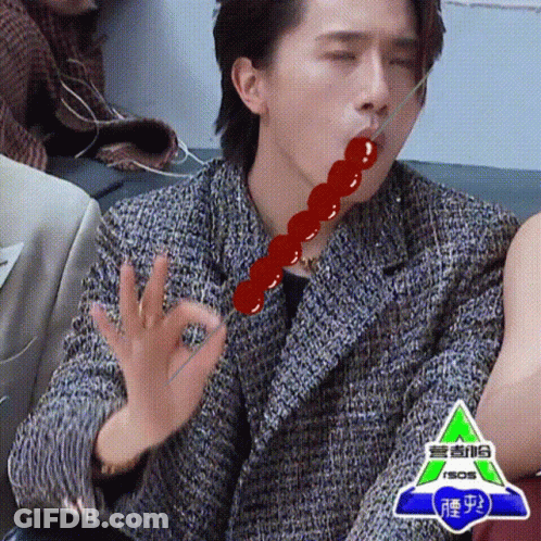 Man Eating Candy Bar With Stick On Couch GIF