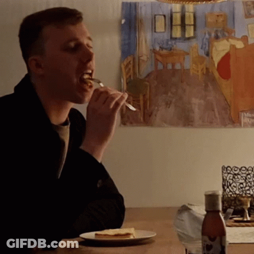 Man Eating Cheese At Table GIF