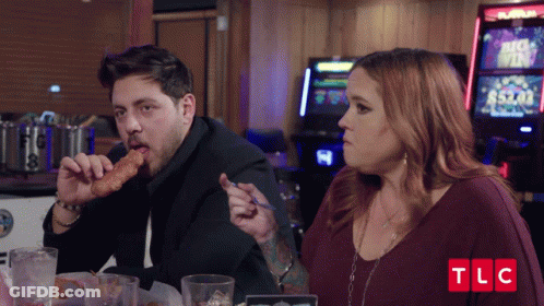 Man Eating Chicken Nugget Woman Looking TLC Logo GIF